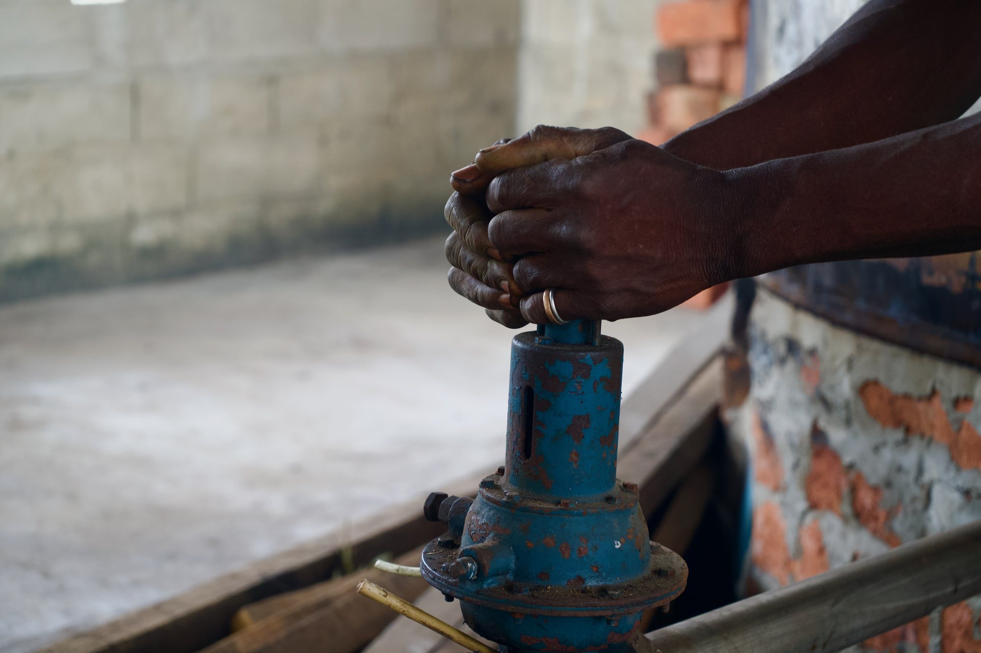 Mains du distillateur sur une vanne de l'alambic